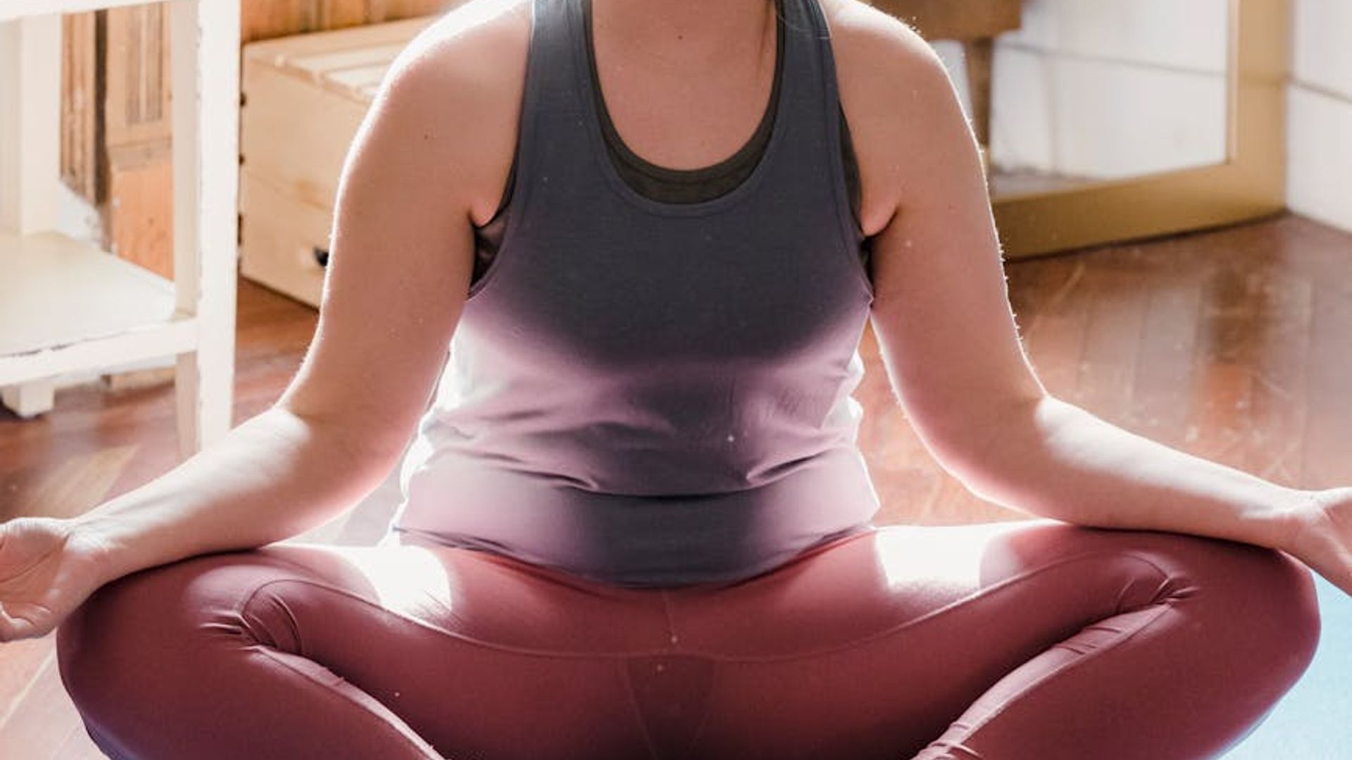 Serene person practicing yoga in a bright open space